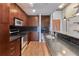 Modern kitchen with stainless steel appliances, granite countertops, and dark wood cabinets at 860 Peachtree Ne St # 1010, Atlanta, GA 30308