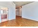 Open living area with hardwood floors and an adjacent bathroom, lit by modern ceiling lights at 860 Peachtree Ne St # 1010, Atlanta, GA 30308