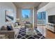 Virtually staged living room with modern decor, hardwood floors, and expansive city views at 860 Peachtree Ne St # 1010, Atlanta, GA 30308