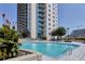Enjoy the community swimming pool with comfortable lounge chairs, set against the backdrop of the building at 860 Peachtree Ne St # 1010, Atlanta, GA 30308