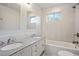 Bright bathroom with a double sink vanity, modern fixtures, and a shower-tub combo at 961 Old Conyers Rd, Stockbridge, GA 30281