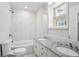 Bathroom with granite countertop and double sinks alongside a pristine, tiled shower-tub combination at 961 Old Conyers Rd, Stockbridge, GA 30281