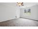 Bright, carpeted bedroom offering a modern ceiling fan and views of the outdoors at 961 Old Conyers Rd, Stockbridge, GA 30281