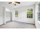 Carpeted bedroom features a built-in closet and sunlit windows, creating a cozy atmosphere at 961 Old Conyers Rd, Stockbridge, GA 30281