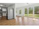 Bright dining room with an adjacent kitchen, large windows, and wood flooring at 961 Old Conyers Rd, Stockbridge, GA 30281