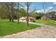 Single story home with front yard and driveway surrounded by a lush green landscape at 961 Old Conyers Rd, Stockbridge, GA 30281