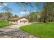 Charming single-story home with a well-maintained lawn and a private driveway at 961 Old Conyers Rd, Stockbridge, GA 30281