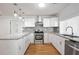 Modern kitchen with stainless steel appliances, granite countertops, and tiled backsplash at 961 Old Conyers Rd, Stockbridge, GA 30281