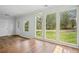 Bright living room boasts floor-to-ceiling windows, wood floors, and a modern light fixture at 961 Old Conyers Rd, Stockbridge, GA 30281