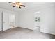 Spacious main bedroom with neutral carpet, large windows, and access to an ensuite bathroom at 961 Old Conyers Rd, Stockbridge, GA 30281