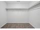 Empty walk-in closet features carpeted floors, white walls, and built-in shelving at 961 Old Conyers Rd, Stockbridge, GA 30281
