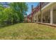 Exterior home view of backyard and porch featuring a green grassy space and iron fence at 10575 Wren Ridge Rd, Alpharetta, GA 30022