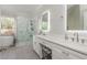 Elegant bathroom showcasing a soaking tub, glass-enclosed shower, and double vanity with modern fixtures at 10575 Wren Ridge Rd, Alpharetta, GA 30022