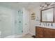 Bathroom featuring a glass door shower, wood cabinets, and a vanity at 10575 Wren Ridge Rd, Alpharetta, GA 30022