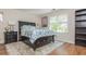 Bedroom offers a plush rug, matching nightstand, and ample natural lighting at 10575 Wren Ridge Rd, Alpharetta, GA 30022