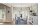 Bright dining area with hardwood floors, adjacent to the kitchen, featuring an elegant table and upholstered chairs at 10575 Wren Ridge Rd, Alpharetta, GA 30022