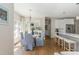 Sunlit dining area with a stylish table, chairs, and elegant lighting, adjoining the modern kitchen at 10575 Wren Ridge Rd, Alpharetta, GA 30022