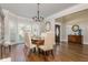 Bright dining room with hardwood floors, chandelier and a view of the entry at 10575 Wren Ridge Rd, Alpharetta, GA 30022