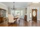 Bright dining room with hardwood floors, chandelier and a view of the front yard at 10575 Wren Ridge Rd, Alpharetta, GA 30022