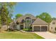 Charming two-story home with well-manicured lawn, a two-car garage, and mature trees enhancing its curb appeal at 10575 Wren Ridge Rd, Alpharetta, GA 30022