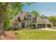 Charming two-story home with well-manicured lawn, a two-car garage, and mature trees enhancing its curb appeal at 10575 Wren Ridge Rd, Alpharetta, GA 30022
