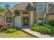Close-up of home's entrance, showcasing the landscaped walkway, detailed door, and updated facade at 10575 Wren Ridge Rd, Alpharetta, GA 30022