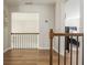 Hallway features hardwood floors, iron railing, and natural light leading to bedrooms at 10575 Wren Ridge Rd, Alpharetta, GA 30022