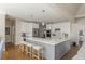 Spacious kitchen featuring a large island, white cabinetry, stainless steel appliances, and hardwood floors at 10575 Wren Ridge Rd, Alpharetta, GA 30022