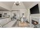 Open-concept living room with fireplace, TV, and seamless flow to the kitchen and dining area at 10575 Wren Ridge Rd, Alpharetta, GA 30022