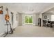 Open living room area with neutral carpet, adjacent dining table, and backyard access at 10575 Wren Ridge Rd, Alpharetta, GA 30022