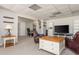 Living room area with neutral carpet, featuring entertainment area and adjacent office space at 10575 Wren Ridge Rd, Alpharetta, GA 30022