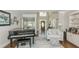 Bright living room features a piano, built in bookshelves, and seating area at 10575 Wren Ridge Rd, Alpharetta, GA 30022