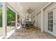 Covered outdoor patio featuring brick flooring, ceiling fans and yard access at 10575 Wren Ridge Rd, Alpharetta, GA 30022