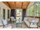 Relaxing screened porch with comfortable seating, ceiling fan, and outdoor views at 10575 Wren Ridge Rd, Alpharetta, GA 30022