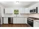 Modern kitchen with white cabinets, granite countertops, and stainless steel appliances at 1753 Detroit Nw Ave, Atlanta, GA 30314
