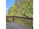 A view of the back deck with railing and trees in the background at 1960 Dakota Nw Dr, Acworth, GA 30101