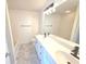 Bathroom with double sinks, white cabinets, updated fixtures, and large mirror above vanity at 1960 Dakota Nw Dr, Acworth, GA 30101