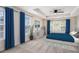 Bedroom showcasing a tray ceiling, blue accents, and natural light from three windows at 1960 Dakota Nw Dr, Acworth, GA 30101