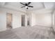 Spacious carpeted bedroom with tray ceiling, ceiling fan, and adjoining bathroom and walk-in closet at 1960 Dakota Nw Dr, Acworth, GA 30101