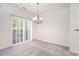 Empty dining room with sliding door leading to a deck and chandelier at 1960 Dakota Nw Dr, Acworth, GA 30101