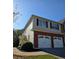 Two-story home with a two-car garage, brick accents, and neutral-colored siding at 1960 Dakota Nw Dr, Acworth, GA 30101