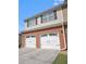 Home featuring a two-car garage with brick accents and complementary siding at 1960 Dakota Nw Dr, Acworth, GA 30101