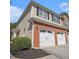 Townhome boasting a two-car garage, brick accents, and neutral siding at 1960 Dakota Nw Dr, Acworth, GA 30101