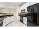 Well-equipped kitchen with black appliances, granite countertops, and tiled backsplash at 1960 Dakota Nw Dr, Acworth, GA 30101