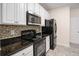 Bright kitchen features granite countertops, white cabinets, and stainless steel appliances at 1960 Dakota Nw Dr, Acworth, GA 30101