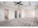 Spacious main bedroom featuring tray ceiling, ceiling fan, and ensuite bathroom and laundry room at 1960 Dakota Nw Dr, Acworth, GA 30101