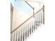 Carpeted staircase features white risers and wooden handrail, offering a clean and inviting transition at 1960 Dakota Nw Dr, Acworth, GA 30101