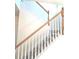 Carpeted staircase with white risers, light wood railing, and natural light at 1960 Dakota Nw Dr, Acworth, GA 30101