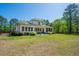 Large backyard features a covered patio area and well-maintained landscaping at 5138 Price Dr, Suwanee, GA 30024