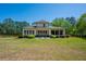 Expansive backyard features a covered patio and shed, surrounded by lush greenery at 5138 Price Dr, Suwanee, GA 30024